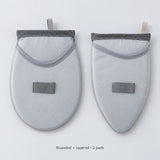 Two garment-steaming pads, one rounded and one tapered.