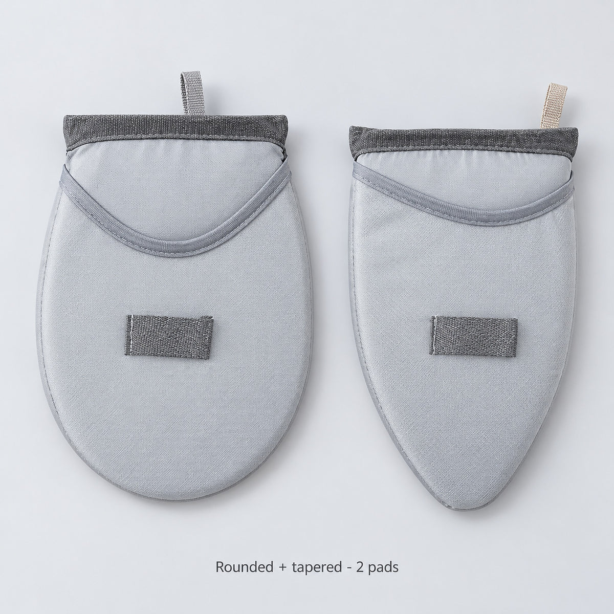 Two garment-steaming pads, one rounded and one tapered.