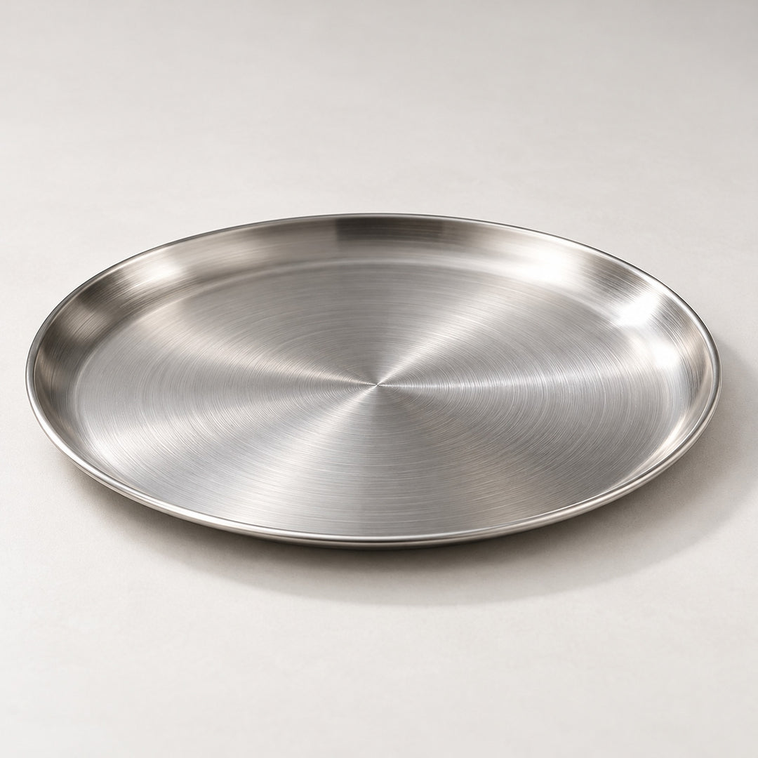 Close view of the brushed silver stainless steel surface and low rolled rim.
