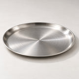 Close view of the brushed silver stainless steel surface and low rolled rim.