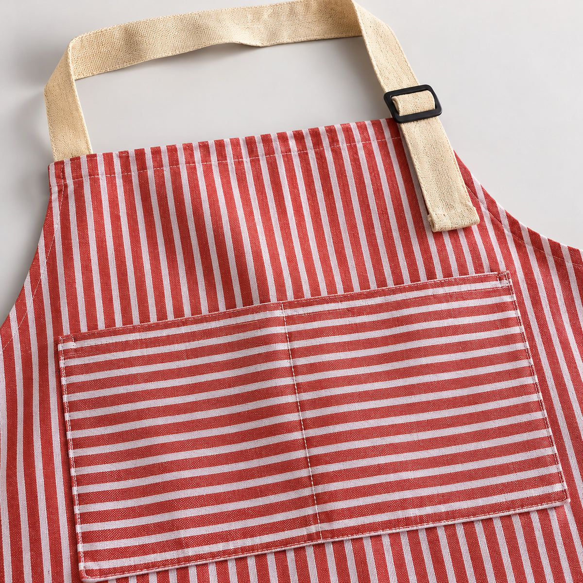 Red striped apron fabric, divided front pocket and adjustable beige neck strap.