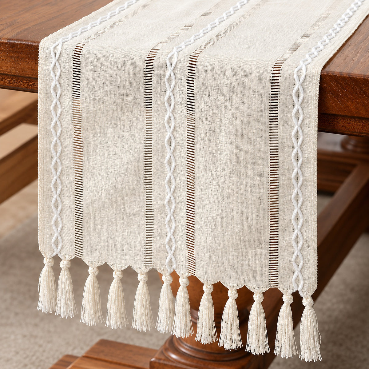 Ivory runner showing scalloped edge, knotted tassels and hemstitch detail.