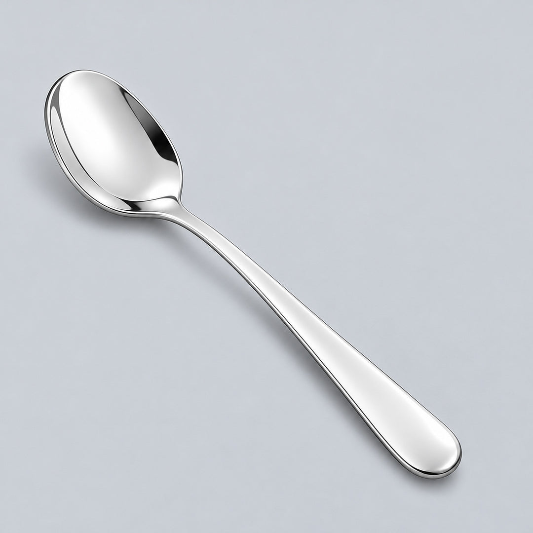 Silver teaspoon showing its shallow oval bowl and rounded metal handle.