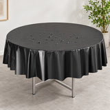 Water droplets on a black disposable PVC round table cover.