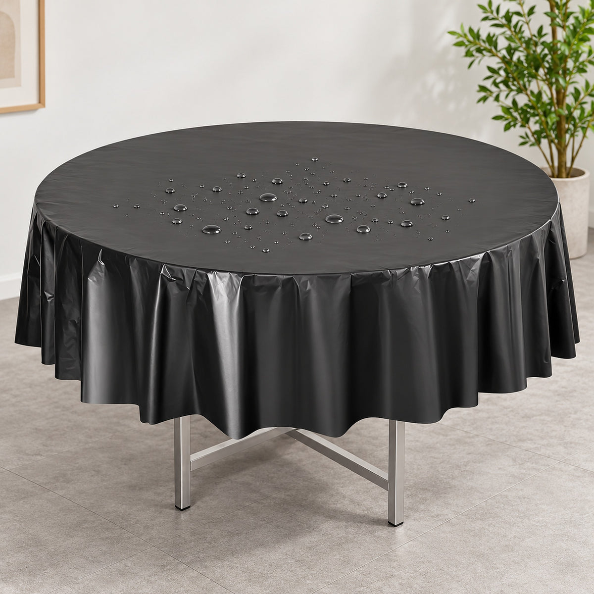 Water droplets on a black disposable PVC round table cover.