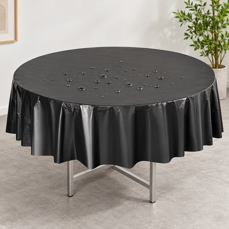 Water droplets on a black disposable PVC round table cover.