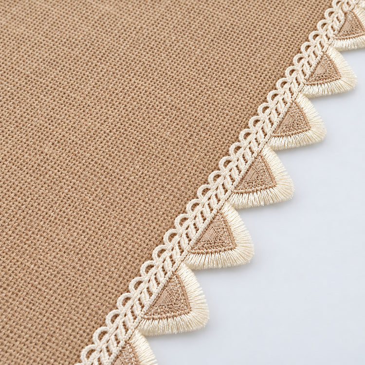 Cream triangular fringe and tan woven runner edge detail.