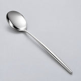 Silver dinner spoon showing its polished bowl and slim metal handle.