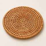 Close-up of handwoven rattan surface and bound round rim.