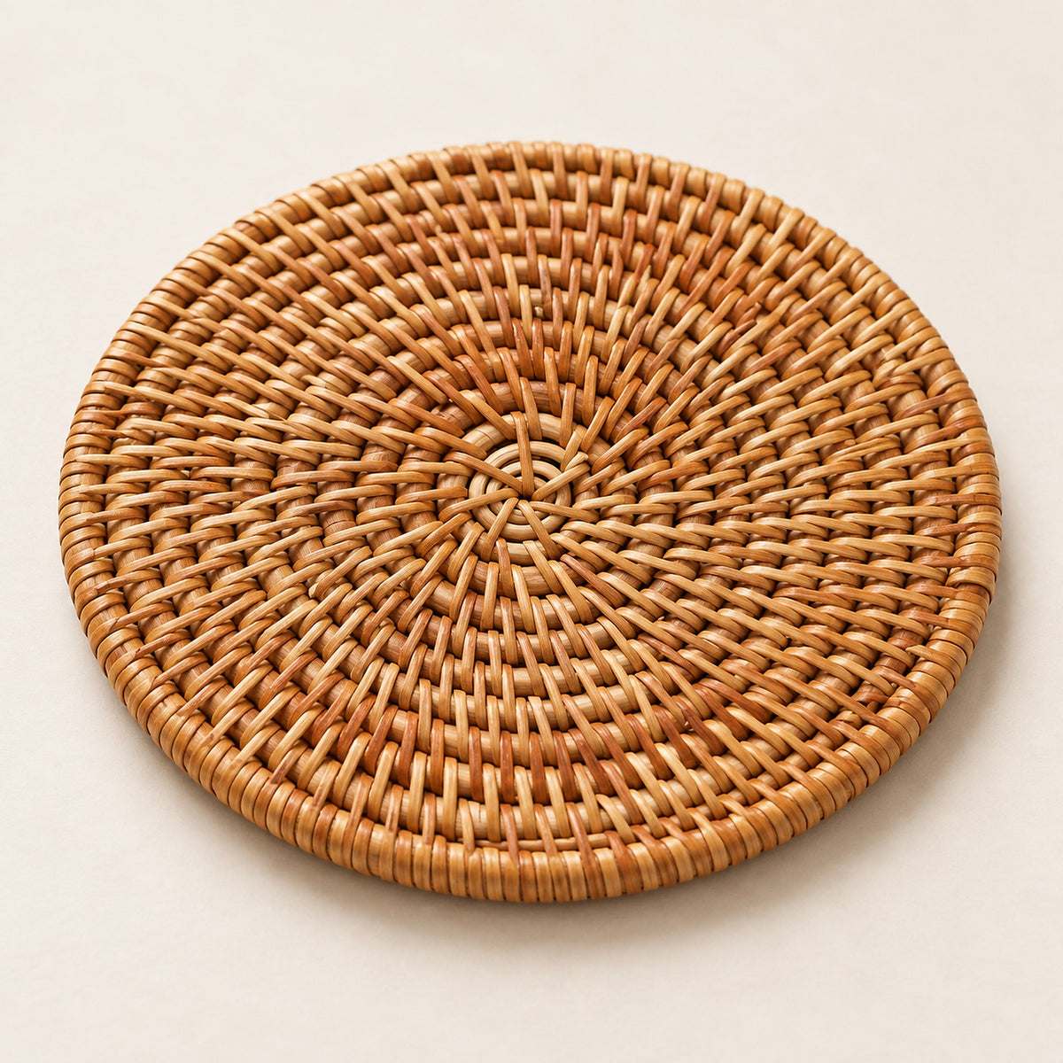 Close-up of handwoven rattan surface and bound round rim.