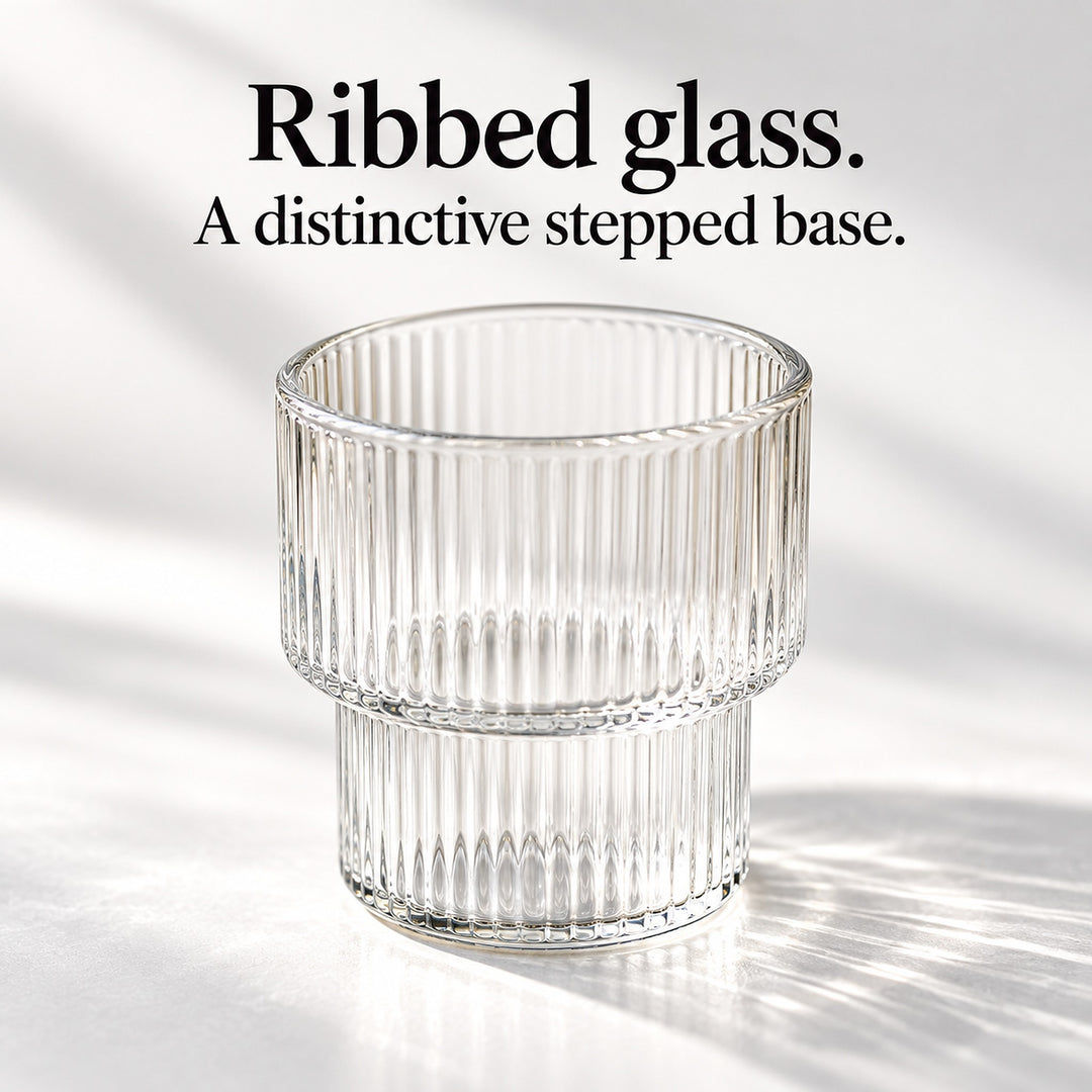 Clear ribbed glass cup with a distinctive narrower stepped base.