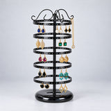 Five-tier black stand with earrings and a necklace on an upper hook.