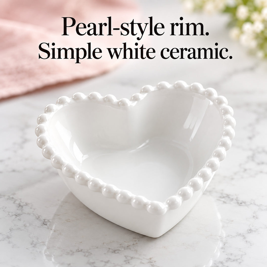 Glossy white heart bowl showing its raised pearl-style rim.