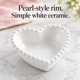 Glossy white heart bowl showing its raised pearl-style rim.