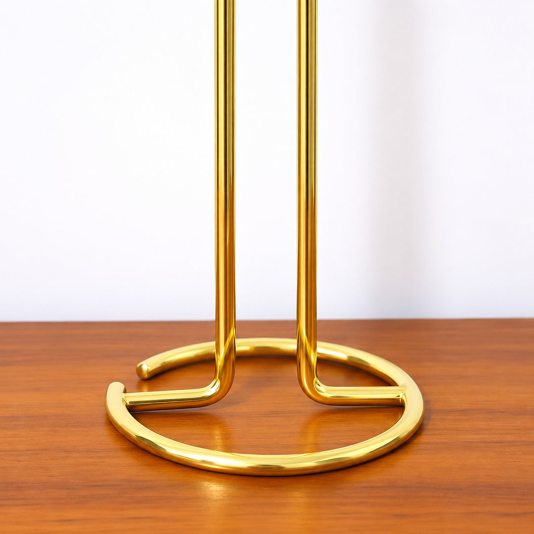 Open circular wire base and bent support rods of the gold stand.