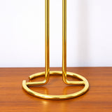 Open circular wire base and bent support rods of the gold stand.