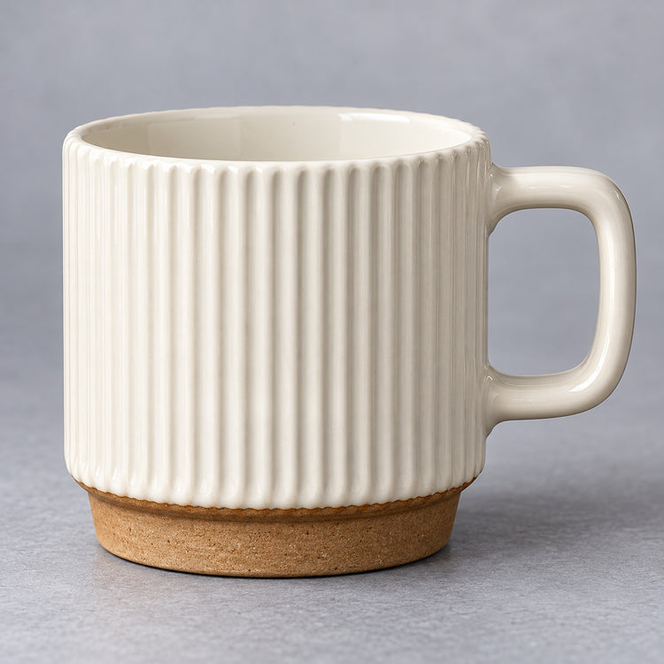 Rounded rectangular handle and glazed rim of the ceramic mug.