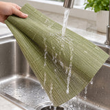 Rinsing one flexible olive-green woven vinyl placemat at the sink.