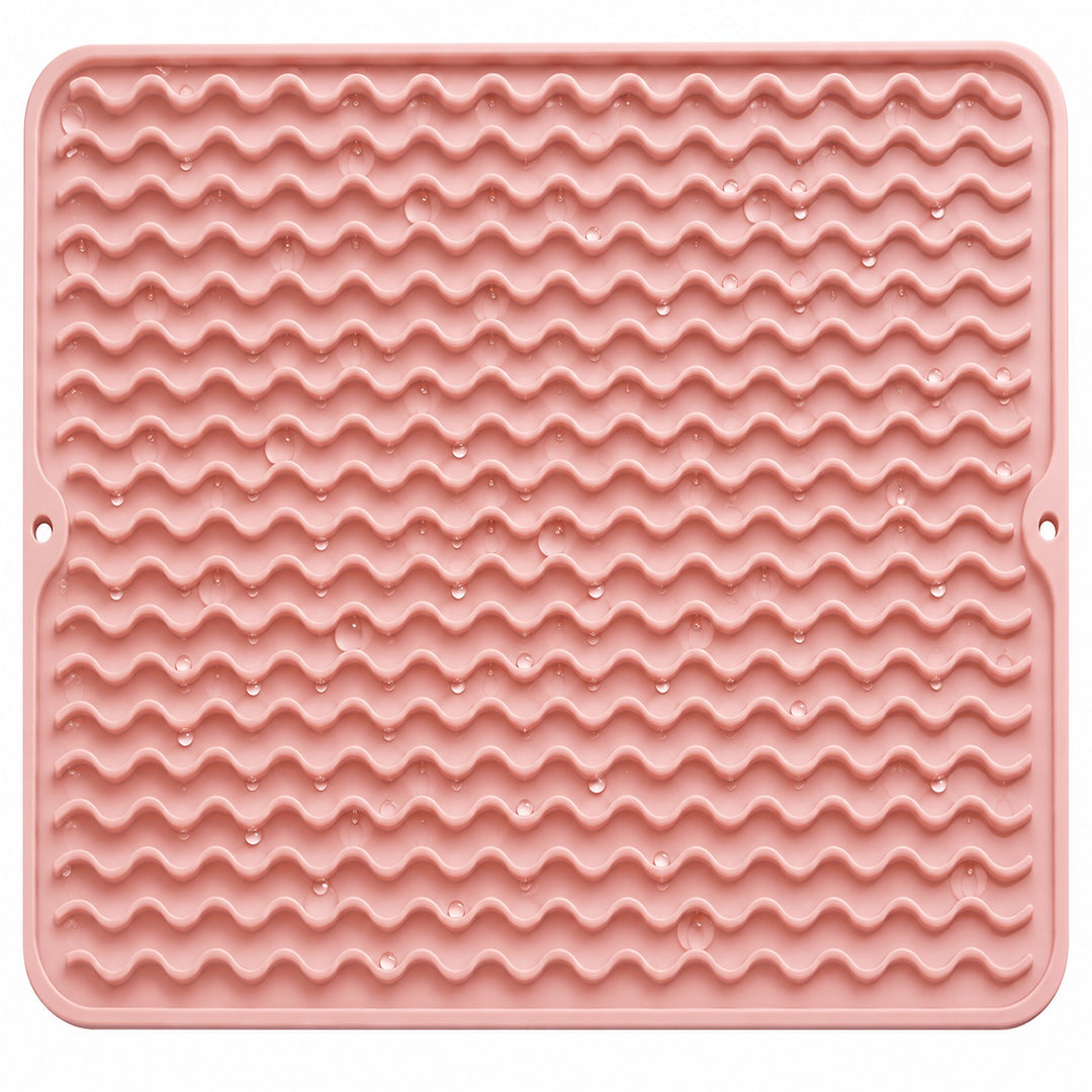 Water droplets on pink silicone mat wavy ridges.
