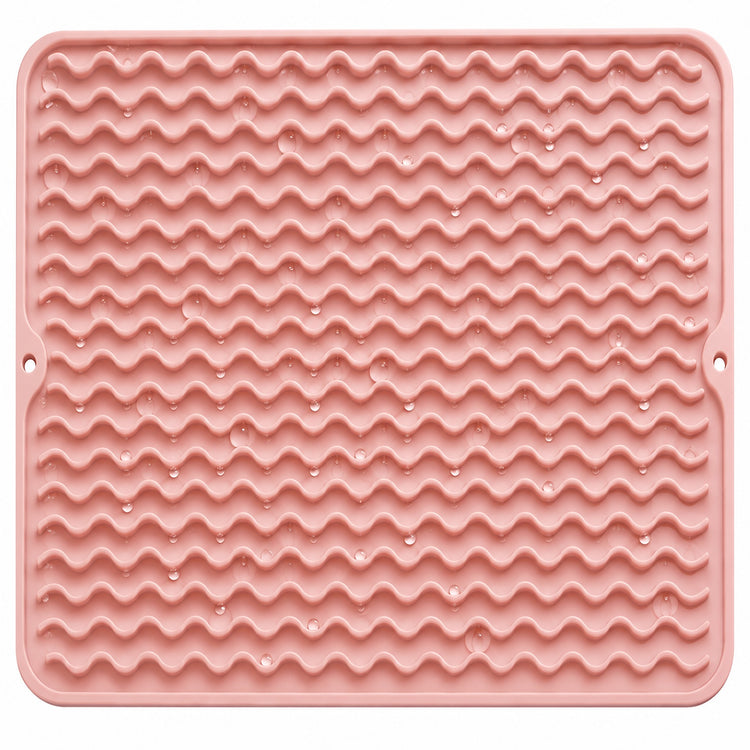 Water droplets on pink silicone mat wavy ridges.