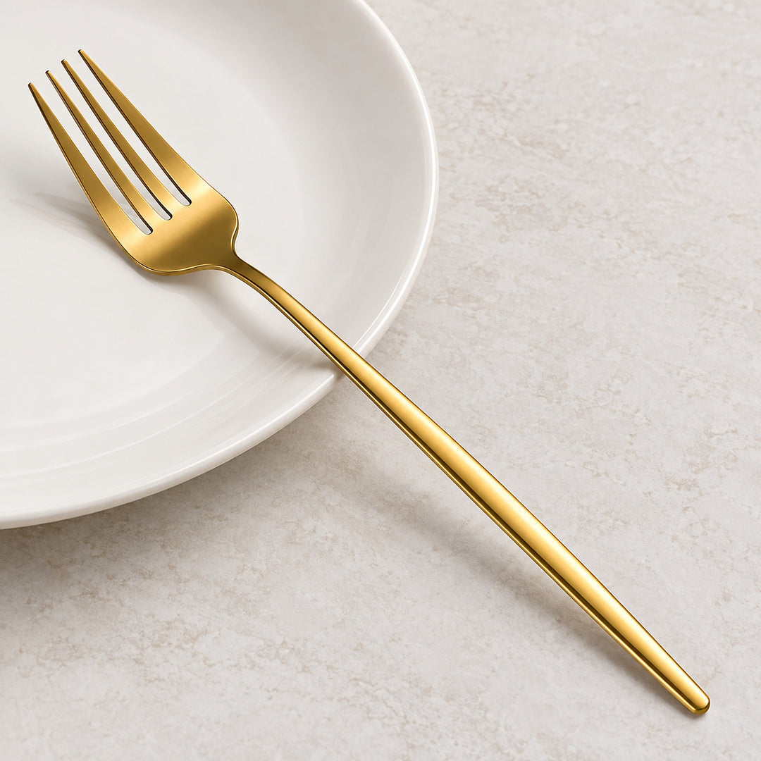 Gold fork showing four slender tines, smooth shoulders and a slim handle.