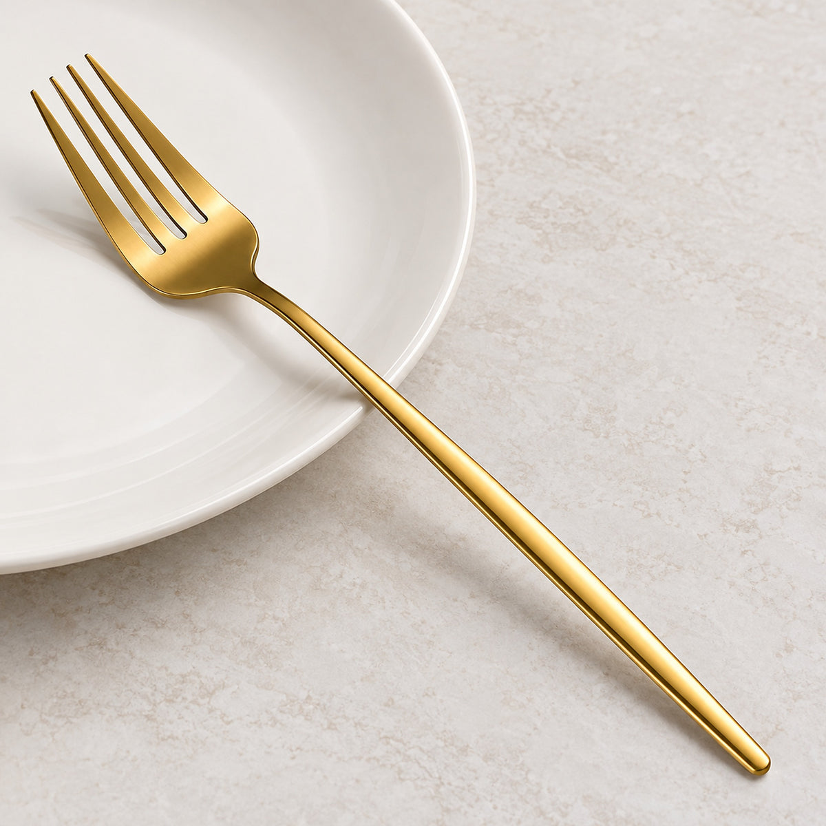 Gold fork showing four slender tines, smooth shoulders and a slim handle.