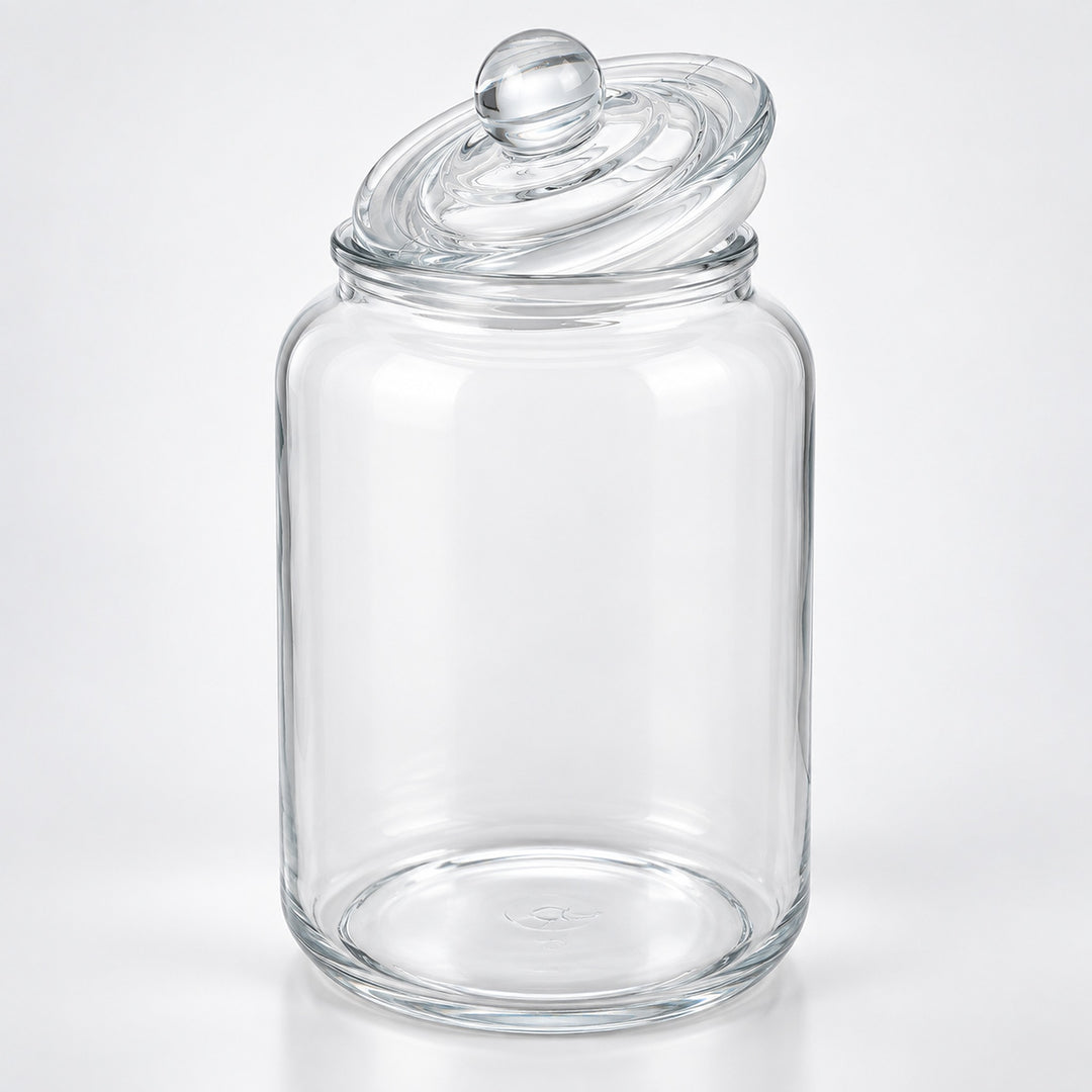 A clear glass jar with a matching glass lid featuring a round knob, photographed on a clean white background.