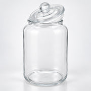 A clear glass jar with a matching glass lid featuring a round knob, photographed on a clean white background.