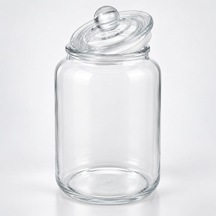 A clear glass jar with a matching glass lid featuring a round knob, photographed on a clean white background.