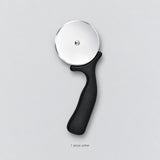 One complete black handled pizza cutter.