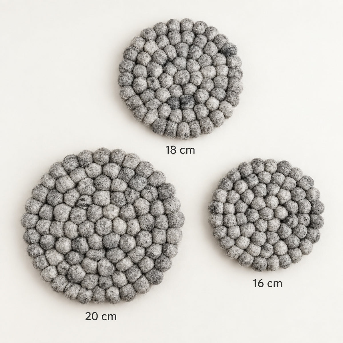 Three round gray felt coasters with a textured bumpy surface, shown on a white background with size labels indicating 18 cm, 20 cm, and 16 cm.