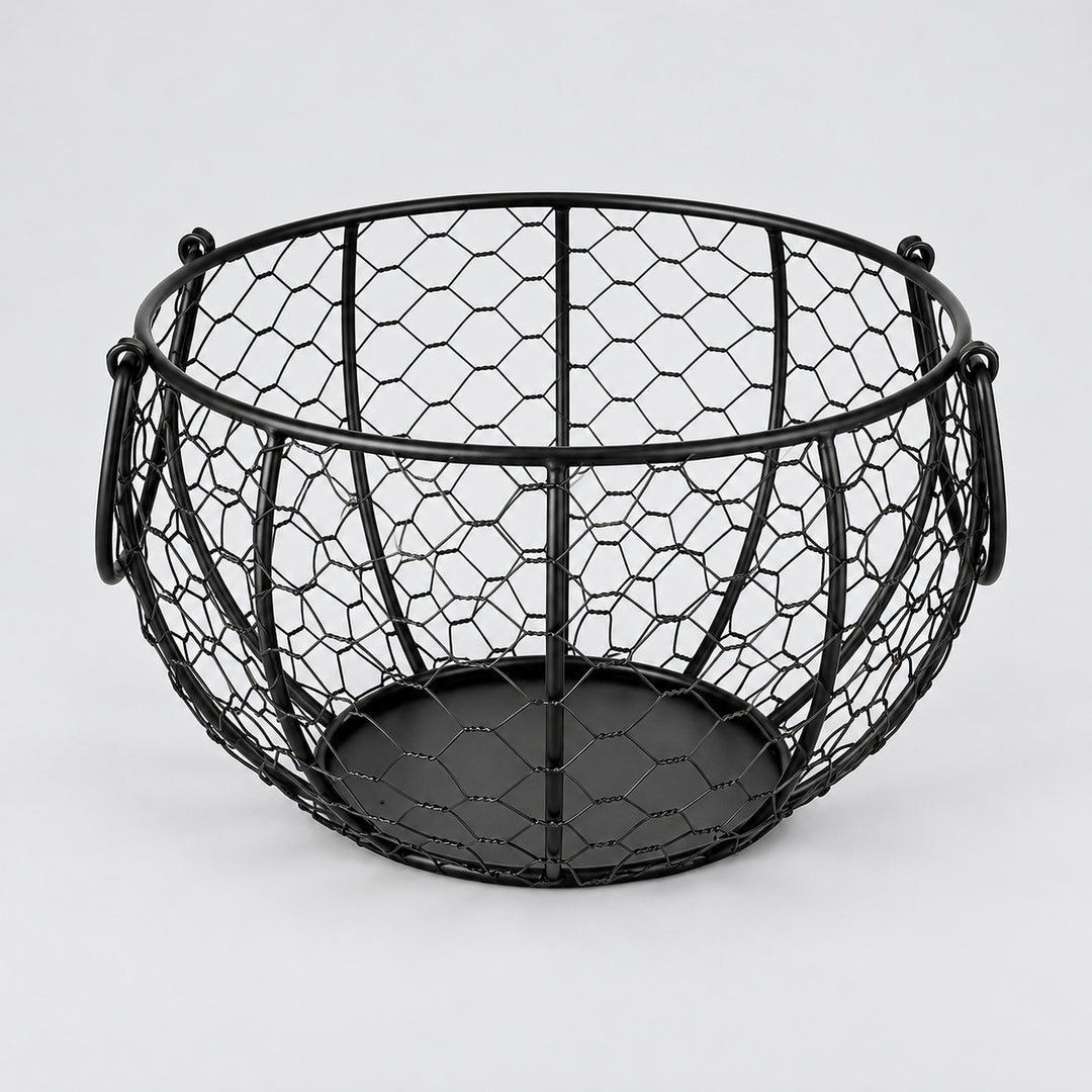 One empty black iron egg basket with two folding handles and a solid circular base.