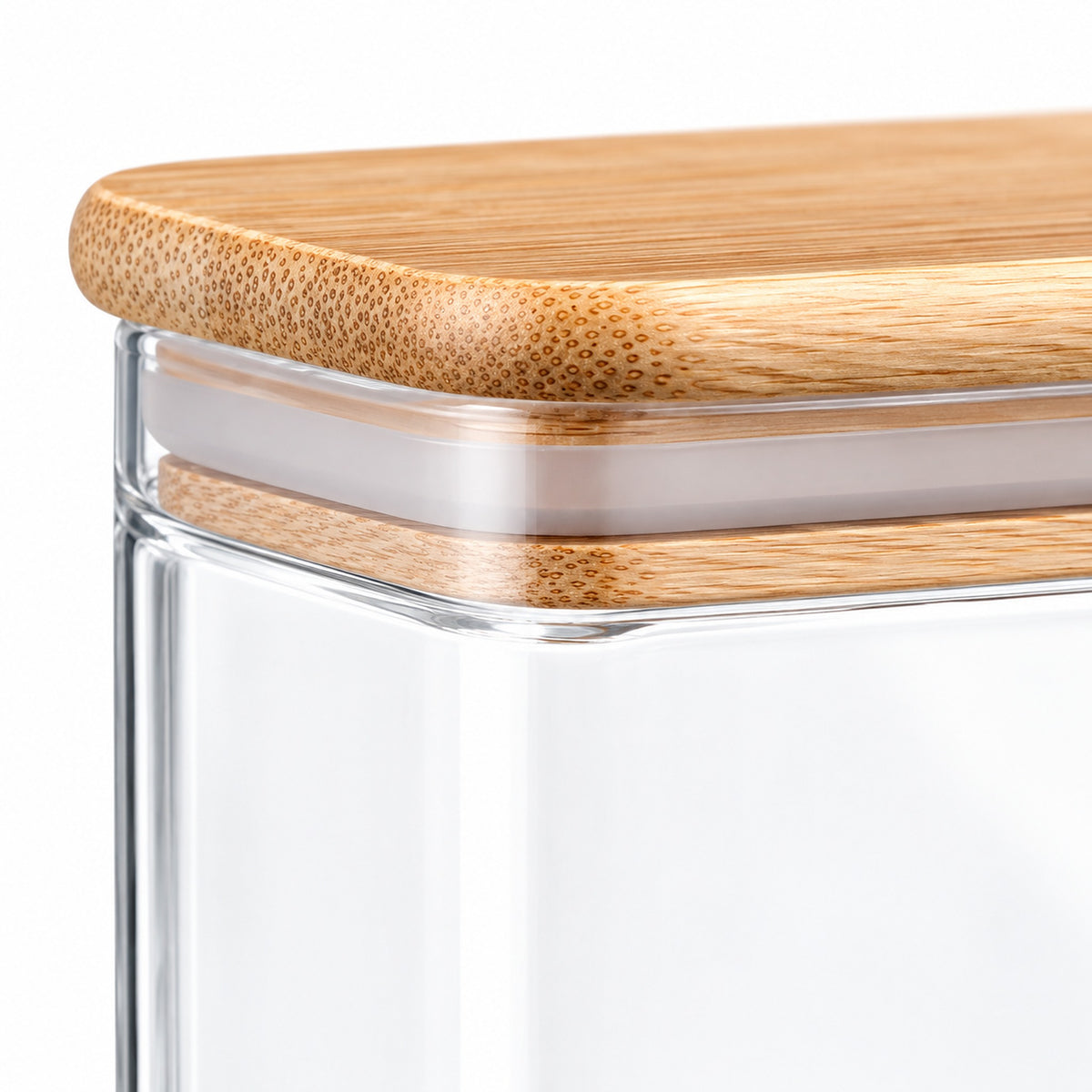 Close-up of a clear glass storage container with a light natural bamboo lid, showing the wood grain and transparent glass body against a white background.