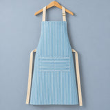 One complete blue striped bib apron with beige neck and waist ties.