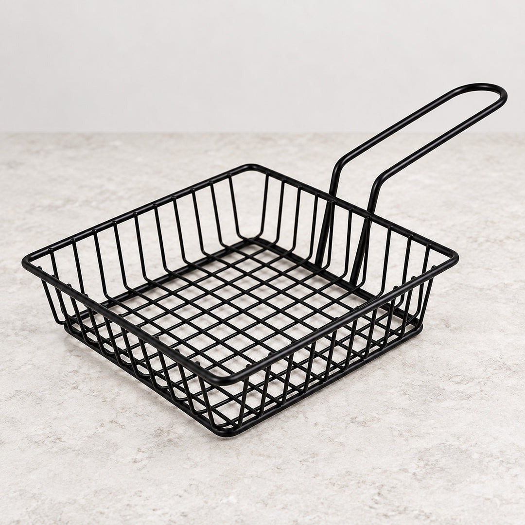 One empty shallow square black iron wire serving basket with handle.
