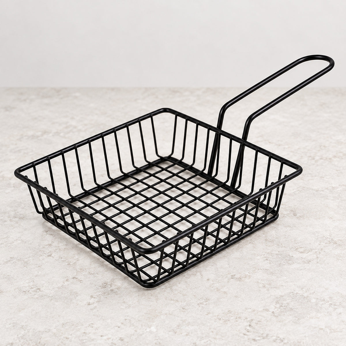 One empty shallow square black iron wire serving basket with handle.