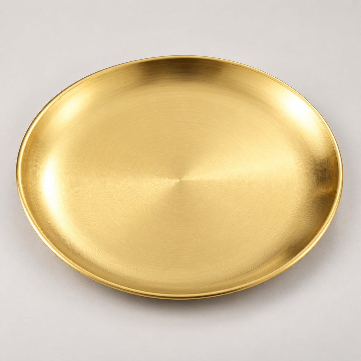 One empty gold stainless steel serving plate with a shallow profile.