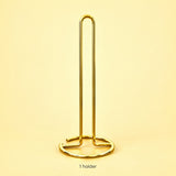 One empty gold paper towel stand; paper roll not included.