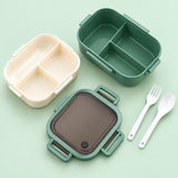 Green lunch box contents: body, upper tray, lid, fork and spoon.
