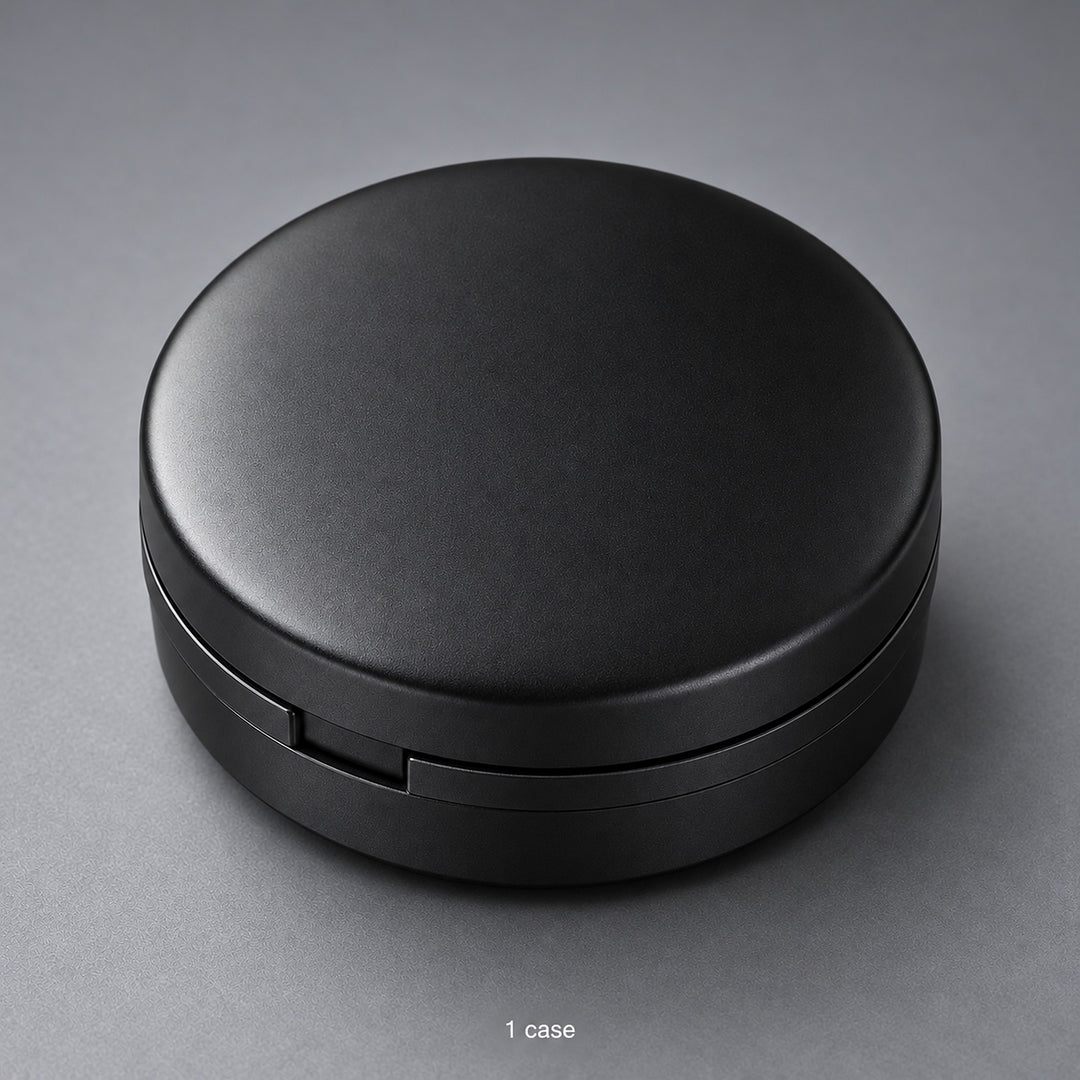 One closed black round storage case; case-only contents.