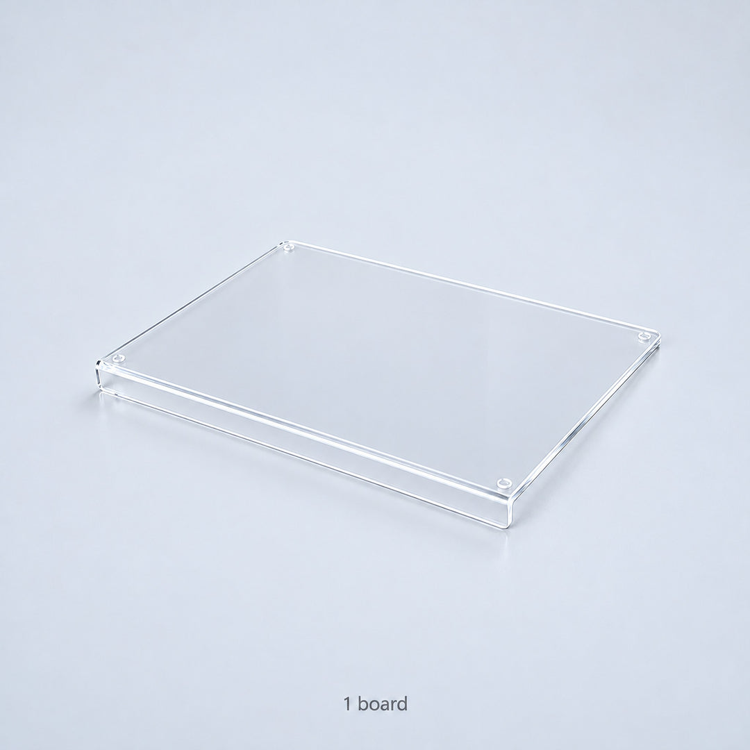 One clear acrylic countertop cutting board with a downward front lip; no accessories included.