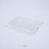One clear acrylic countertop cutting board with a downward front lip; no accessories included.