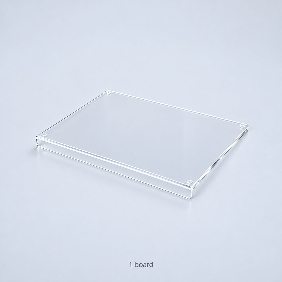 One clear acrylic countertop cutting board with a downward front lip; no accessories included.