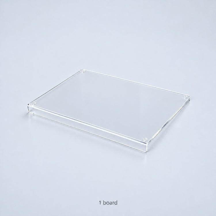 One clear acrylic countertop cutting board with a downward front lip; no accessories included.