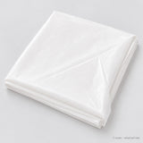 One folded white plastic table cover in selected size.
