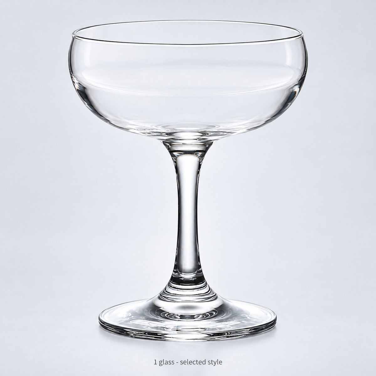 One empty coupe glass in the selected style.