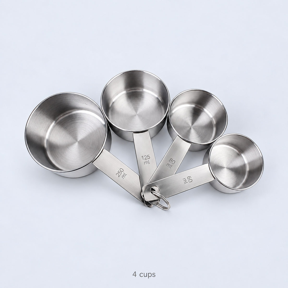 Four empty measuring cups and their joining ring; cups-only set.