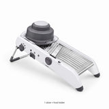 One complete white mandoline slicer with its gray food holder.