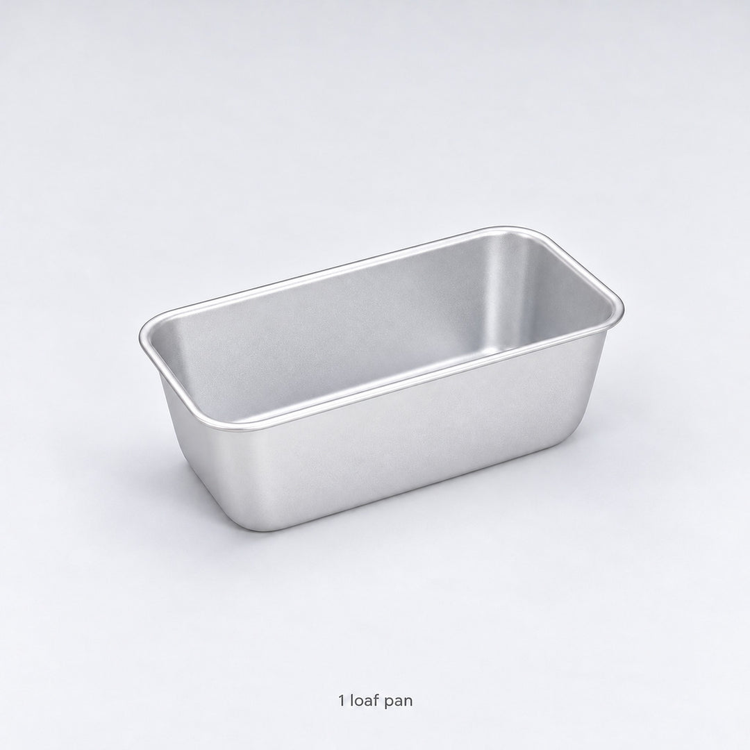 One empty anodized aluminum loaf pan included, without a lid.