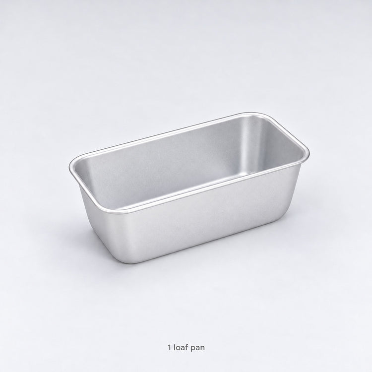 One empty anodized aluminum loaf pan included, without a lid.